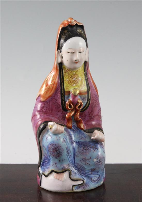 A Chinese famille rose enamelled porcelain seated figure of Guanyin, Jiaqing period, 21cm